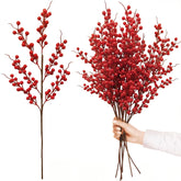 Red berry branches with a hand holding a bundle on a white background